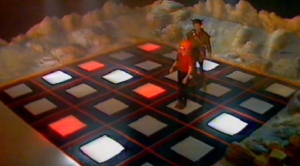 Characters doing a challenge on a colourful grid of squares