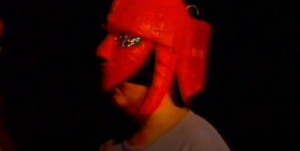 Guy wearing a red mask with glasses
