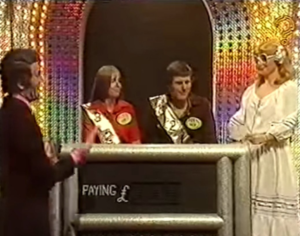 Host laughing with contestants