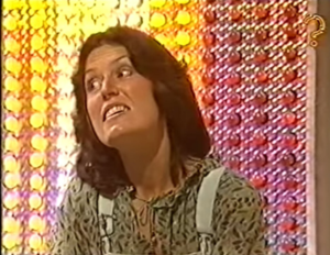 Contestant looking shocked while smiling looking into the distance