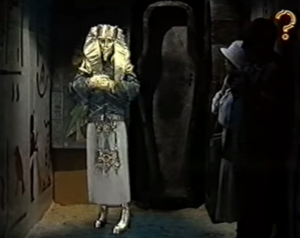 Person wearing a mummy mask with crossed arms