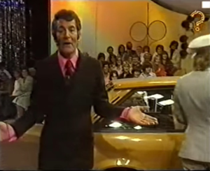Host stood in front of a yellow car