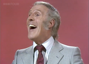 Host laughing looking into the distance away from the camera