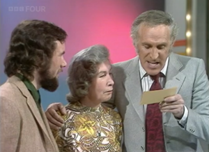 Contestant and host reading from a card