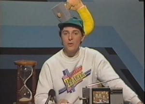 A teacher on the show wearing a funny hat