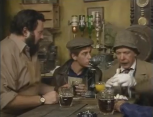 Screenshot from episode 4 characters sat with drinks